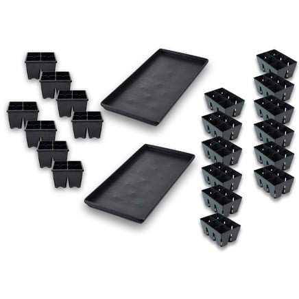 Empty black trays and seedling trays neatly arranged. The black trays are ready to be filled with soil, while the seedling trays await the emergence of delicate young plants.